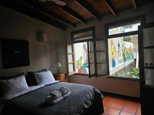 a bedroom with a bed with a stuffed animal on it at Posada Gotan in Buenos Aires
