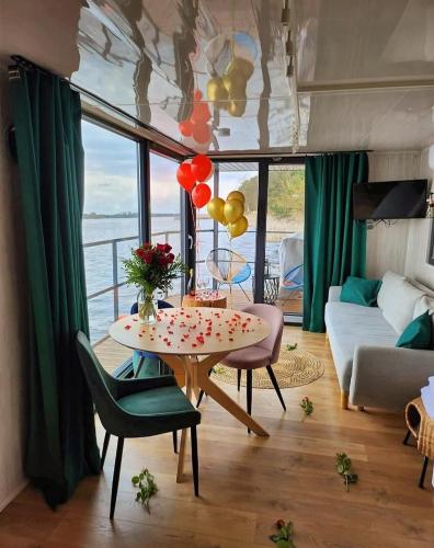 a living room with a table with balloons on it at Nad Narvią in Serock
