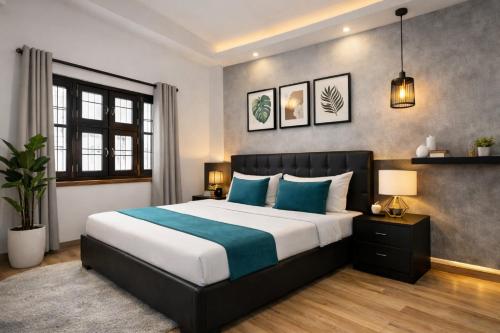 a bedroom with a large bed with blue pillows at Hotel HP Palace in Gorakhpur