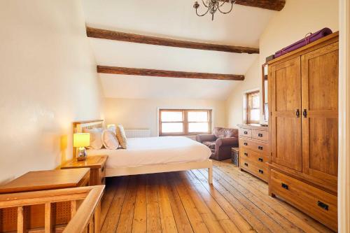 a bedroom with a bed and a desk and a couch at Host & Stay - Sea Haven in Staithes