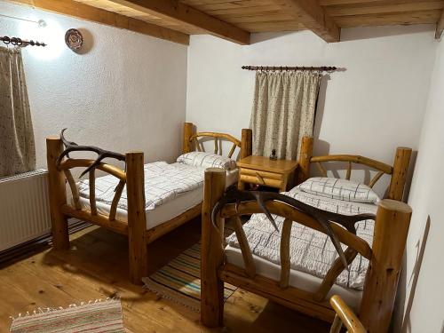a room with three bunk beds in a house at Cabana Poiana in Rusca