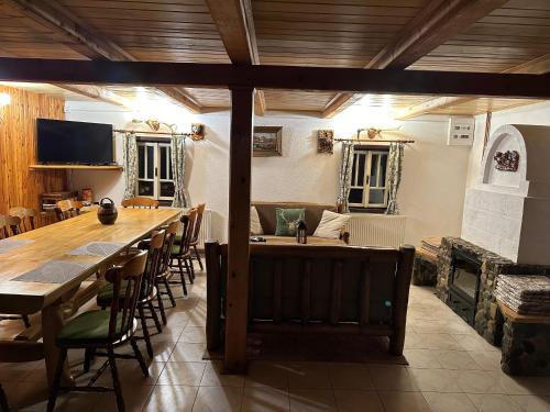 a large dining room with a long table and chairs at Cabana Poiana in Rusca