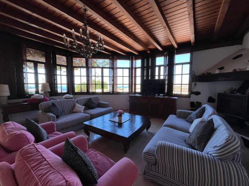 a large living room with couches and a table at Casa Tara - 5 bedroom, 4 bathroom villa with private pool in Mácher