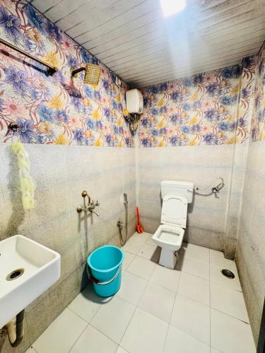 a bathroom with a toilet and a sink at Baba s Villa in Lonavala