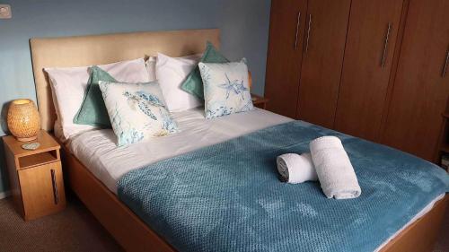 a bed with two rolled up towels on it at 4 Meadow View in Woolacombe