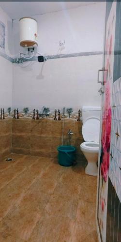 a bathroom with a toilet in a room at ANS Green Villa in Yercaud