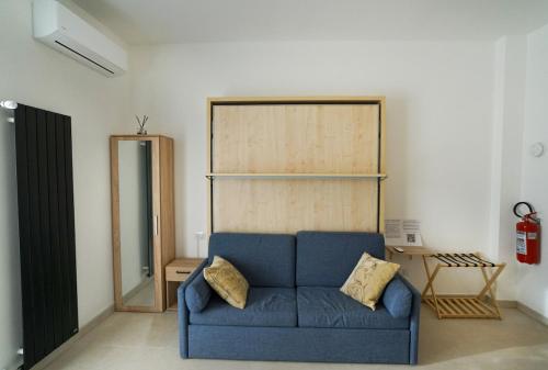 a living room with a blue couch in a room at Blue Iris - Varese - Laghi Svizzera in Varese