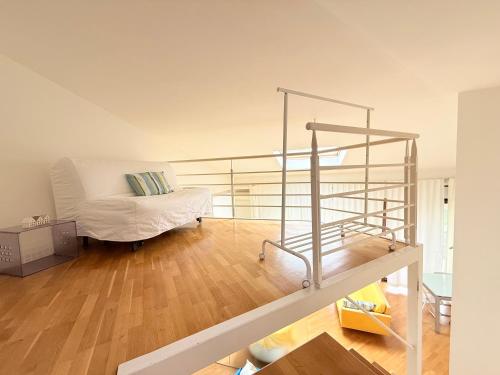 a living room with a bed and a staircase at SE251 - Marzocca, quadrilocale comodo al mare e ai servizi in Marzocca di Senigallia