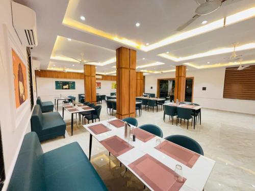 a dining room with tables and chairs and tablesktop at Vantara Gir Resort in Sasan Gir