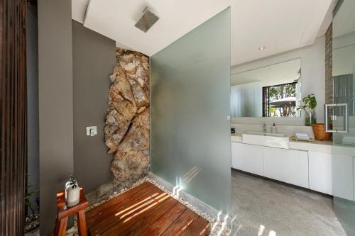 a large bathroom with a stone wall at The View in Taling Ngam Beach