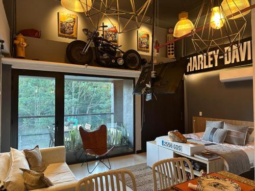 a bedroom with a bed and a motorcycle on the wall at Hotel Rioverde Loft cerca De Aeropuerto Jmc in Rionegro