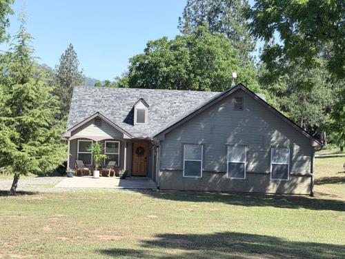 a gray house with a door and a yard at Walnut Grove 2BD 1Bath in Oakhurst