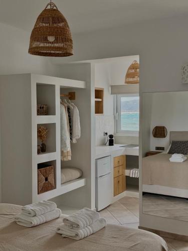 a bathroom with two towels on a bed and a sink at San Salvatore in Zakynthos