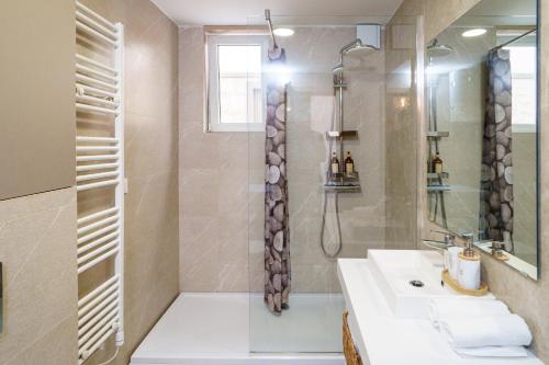 a bathroom with a sink and a shower at Apartments with Pool 5 Min Walk to Beach in Igalo