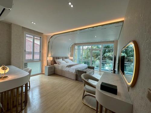 a bedroom with a bed and a table and chairs at IP on HOME 1 in Jomtien Beach