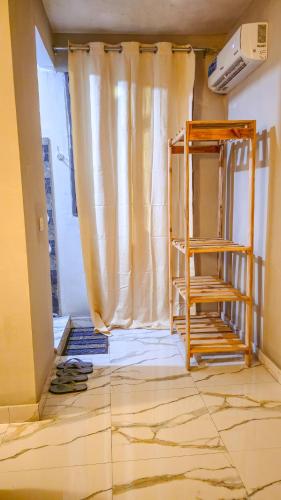 a room under construction with a curtain and a ladder at 7G Residency Bwejuu in Bwejuu