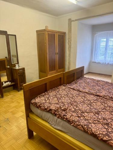 a bedroom with a bed and a dresser in it at Zámek Hošťálkovy in Hošťálkovy