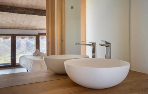 a bathroom with a white bowl sink on a wooden counter at Benaki 99 in Ladines