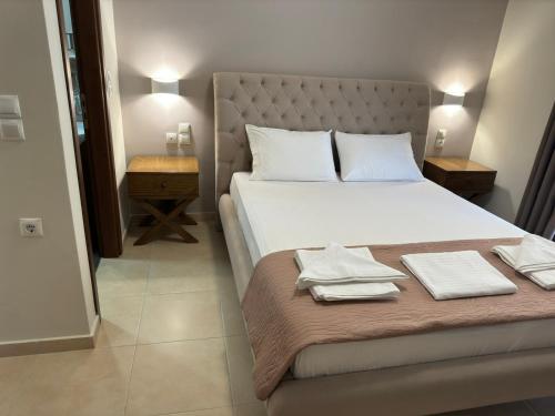 a bedroom with a bed with towels on it at K & A Studios 2 in Nydri