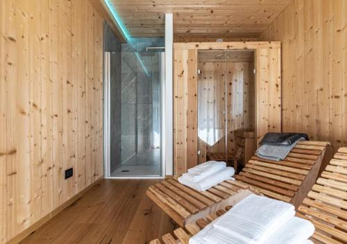 a sauna with wooden walls and wooden floors and towels at Ciasa Fatati' in Pinzolo