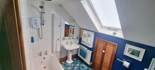 a bathroom with a tub and a sink and a bath tub at Priory Stream, Lower Priory, Pembrokeshire in Milford Haven