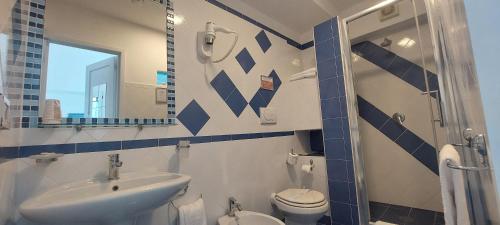 a bathroom with a sink and a toilet and a mirror at Villa Flavia - Adults Only in Ponza