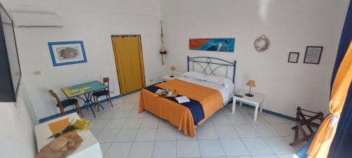 a bedroom with a bed and a table and chairs at Villa Flavia - Adults Only in Ponza