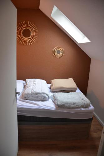 a bed in a room with two clocks on the wall at Cauterets Mountain Nest in Cauterets