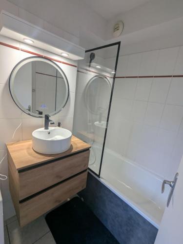 a bathroom with a sink and a mirror at Cauterets Mountain Nest in Cauterets