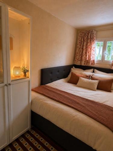 a bedroom with a large bed with a window at Maisonette in Saint-Raphaël