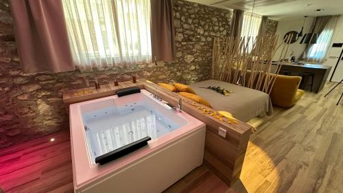 a large bath tub in a room with a bed at Suite spa civico 4 in Follonica