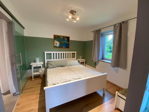 a bedroom with a white bed and a window at Wohnung am Rande der Nordheide in Welle