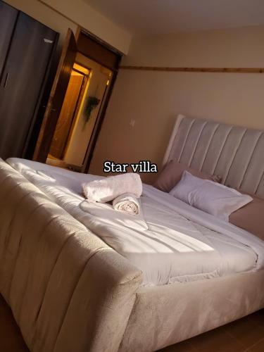 a bed with two towels on top of it at Star Villas Nyahururu in Nyahururu