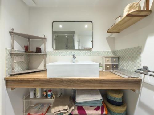 a bathroom with a white sink and a mirror at L'échappée in Collobrières