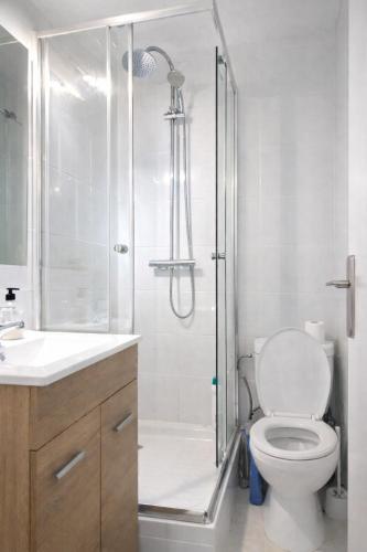 a bathroom with a shower with a toilet and a sink at Rooms in Palma Center in Palma de Mallorca