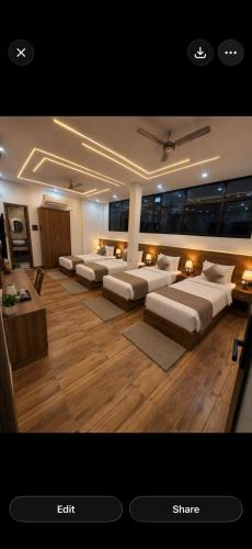 a room with a bunch of beds in it at Hotel Shree Ji in Tālbahat