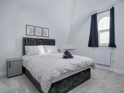 a bedroom with a bed with a black and white comforter at Dwell Living North Bridge Apartments in Sunderland