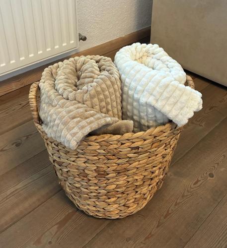 two baskets sitting on the floor in a room at Garten Apartment Diwoky in Sankt Gilgen