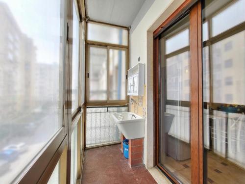 a bathroom with a sink and a window at Appartamento Miramare in Follonica