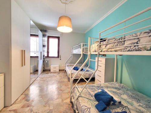 a bedroom with three bunk beds in a room at Appartamento Miramare in Follonica