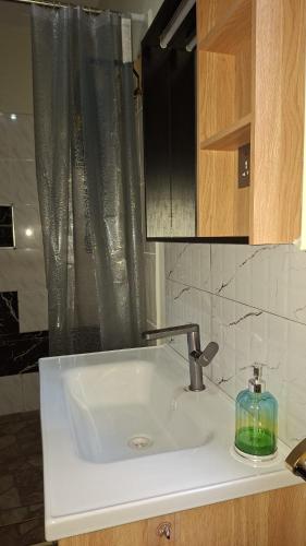 a bathroom sink with a soap dispenser on it at Amerix resorts and adventures in Diani Beach