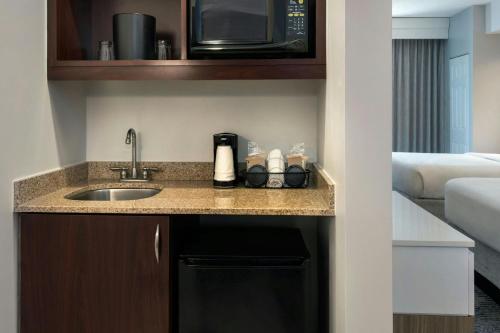 a kitchen with a sink and a microwave at SpringHill Suites Pittsburgh Mills in Tarentum