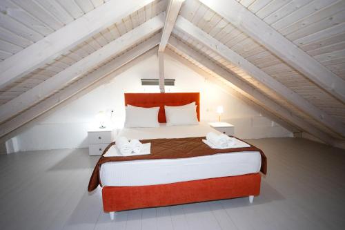 a bedroom with a large bed in a attic at Central Hotel in Parga