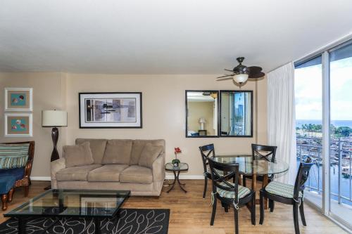 a living room with a couch and a glass table at Ilikai Marina 984 in Honolulu