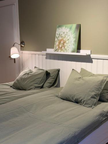 a bedroom with two beds with a picture on the wall at Vörderåsgården in Transtrand