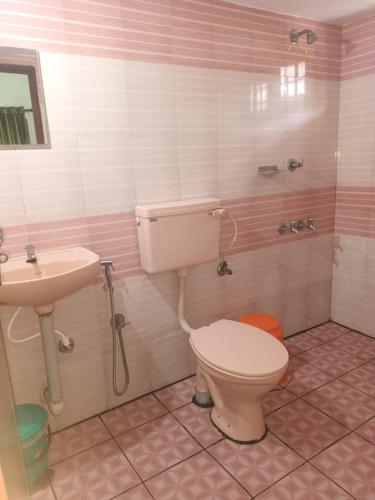 a bathroom with a toilet and a sink at S P Nettoor in Cochin