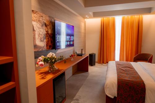 a hotel room with a bed and a television at TubHotel in Grottazzolina