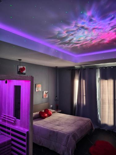 a bedroom with a bed with a purple ceiling at Suite Romantica con Jacuzzi e Sauna in Porto Empedocle