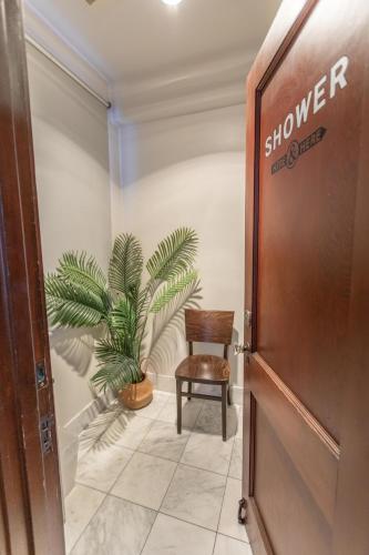 a chair and a plant in a room at Commodore Hotel in Astoria, Oregon