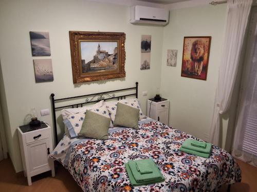 a bedroom with a bed with green towels on it at Imperiale in Sarzana